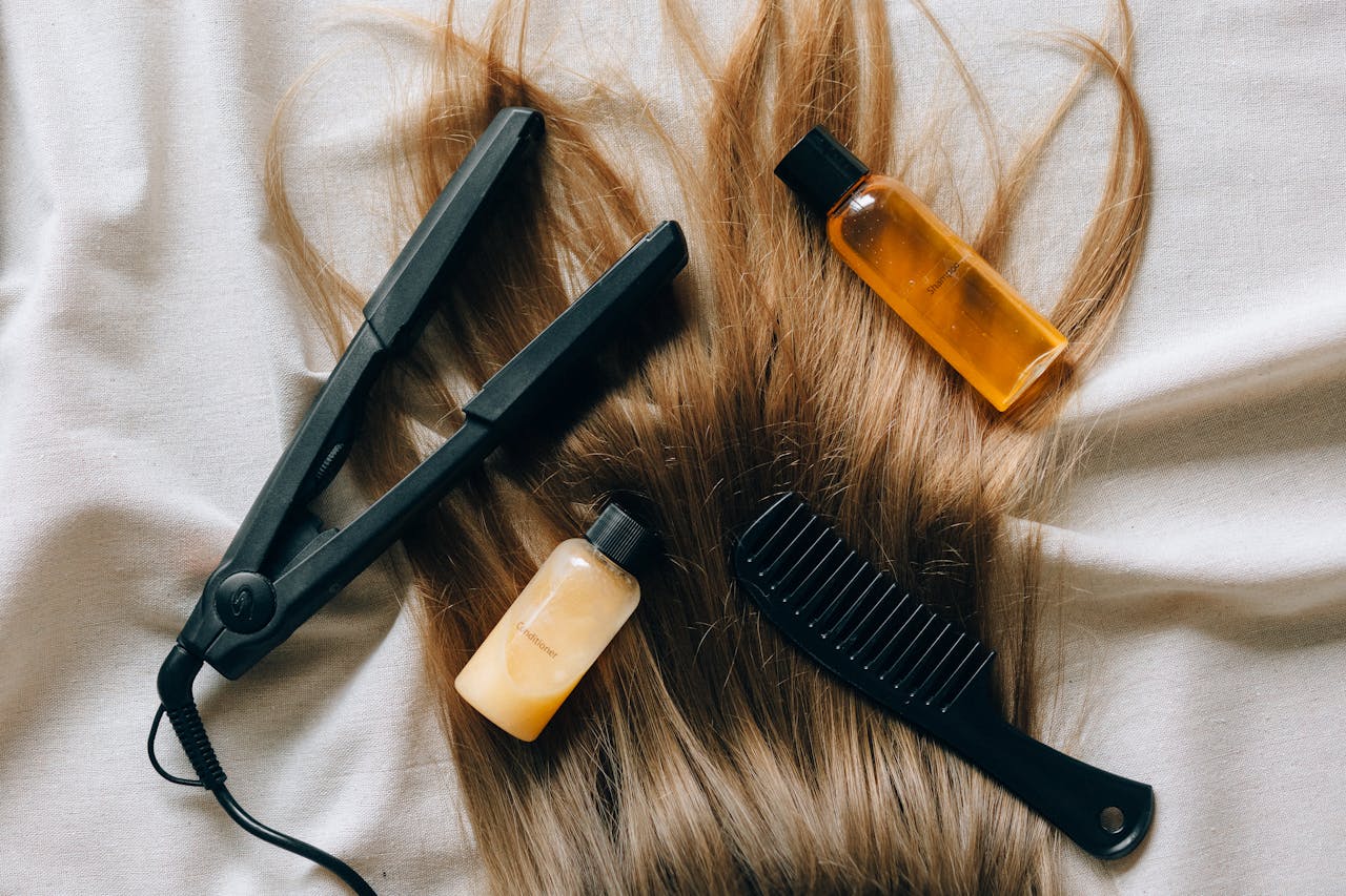 Aesthetic flat lay of hair products and tools for styling and grooming.